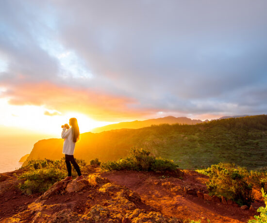 mountain sunrise with lone hiker